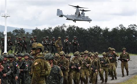 Australian, US, Filipino militaries practice retaking an island in a drill along the South China Sea